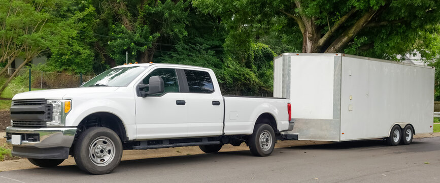 Pickup truck with enclosed trailer attached for hauling support